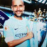 Pep Guardiola with the Premier League trophy